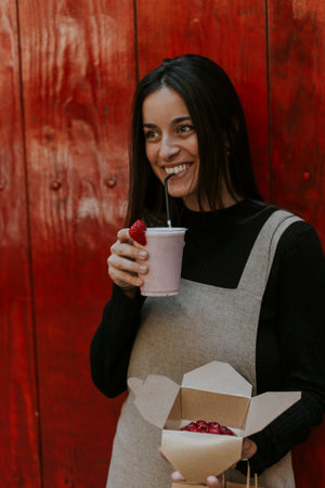Girl enjoying a milkshake on the streetの写真素材