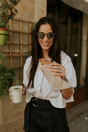Classy Woman enjoying her breakfast on the streetの写真素材