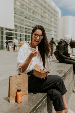 Woman enjoying food perfect content for social networksの写真素材