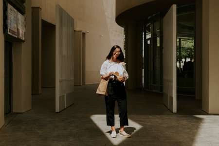 Woman enjoying her takeaway in the cityの写真素材