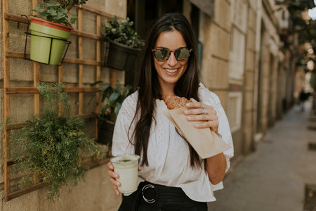 Woman enjoying food perfect content for social networksの写真素材