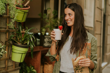 Woman enjoying a strawberry milkshake