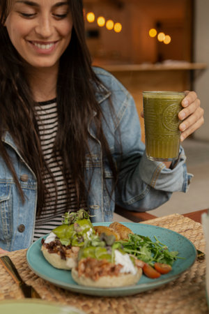 Woman enjoying a delicious and healthy vegan mealの写真素材