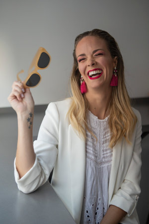 Woman smiling while putting her makeup onの写真素材