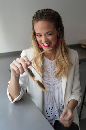 Woman smiling while putting her makeup onの写真素材