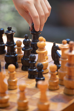 A person hand picking up chess piecesの写真素材