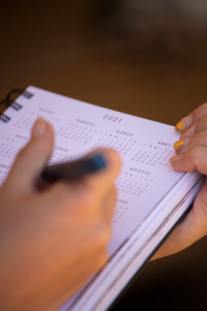 Woman holding her agenda and writingの写真素材