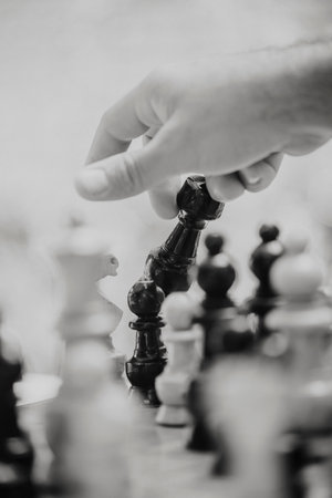 A hand holding a chess piecesの写真素材