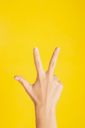 hand making number three on color backgroundの写真素材