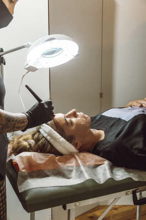 woman receiving a facial in a beauty salonの写真素材