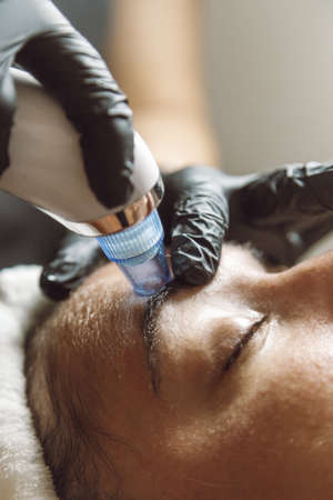 woman receiving a facial in a beauty salonの写真素材