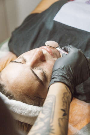 woman receiving a facial in a beauty salonの写真素材