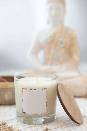 meditation space with candles and woman in backgroundの写真素材