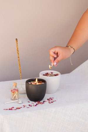 woman lighting a candle in her homeの写真素材