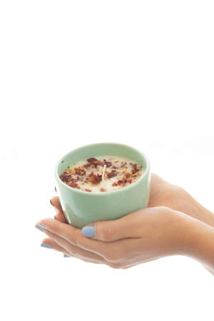 woman holding a candle in a white backgroundの写真素材