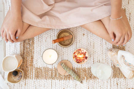 meditation space with candles and woman in backgroundの写真素材