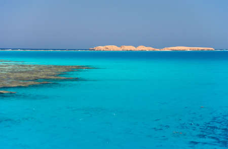 The red sea a coral reef, island on horizonの写真素材