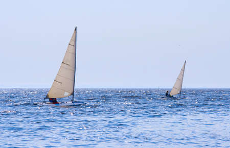 Regatta of sailing boats on the sea in solar windy dayの写真素材