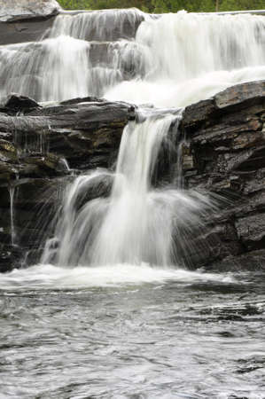 Frothy mountain stream through boulders