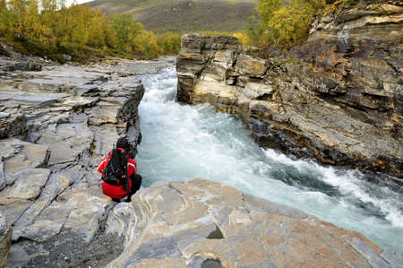 Abisko canyon in Autumn and a hiker