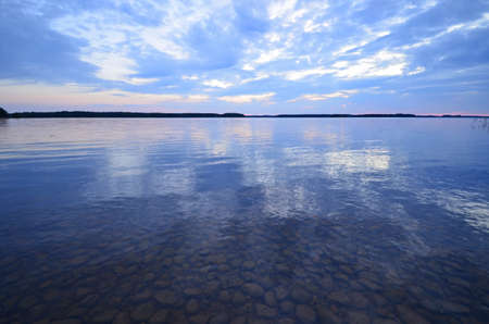Calm lake reflection at midnight lightの写真素材