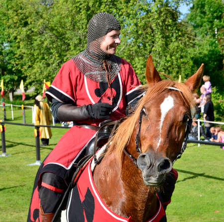 Vittinge, Sweden - June 26  Unidentified people in knight armor on the horse during tournament reconstruction near Vittinge old church on June 26, 2014 in Vittinge, Swedenのeditorial素材