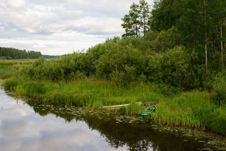 Calm lake reflection at sunsetの写真素材
