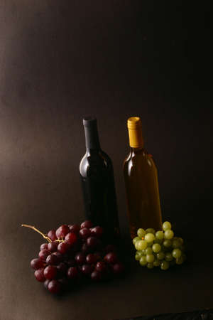 2 bottles of wine with grapesの写真素材