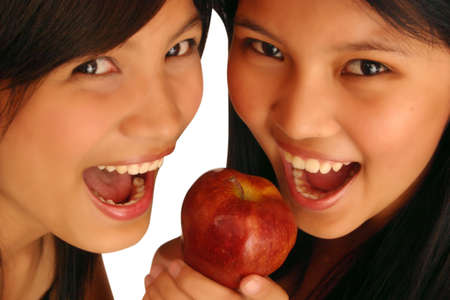 Two woman about to eat an appleの写真素材