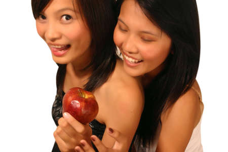 Two woman with an appleの写真素材