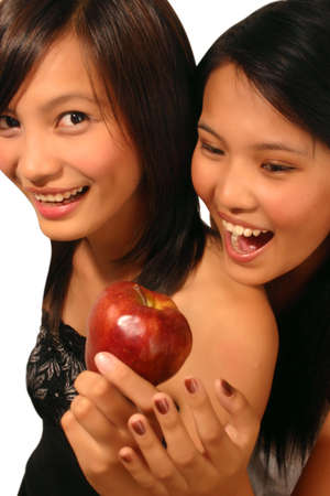 Two woman with an appleの写真素材