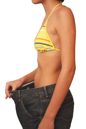Woman showing how much she has lost weight by putting on an old jeans