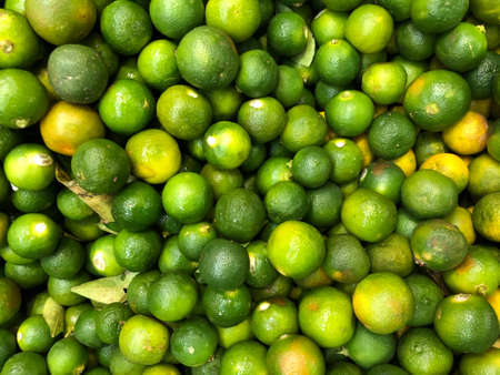 Lot of fresh and raw ripe lime. Selective focus. This image may contain noise, blurry clouds due to...