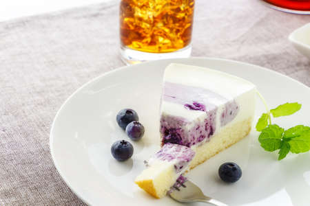 A gelatin cheesecake on the white plate with forkの写真素材