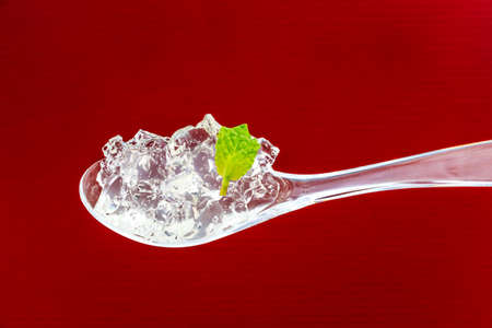 Yuzu Jelly on the spoon with mint leafの写真素材
