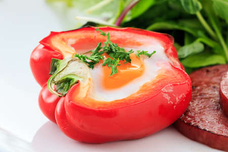 Grilled egg in the red paprikaの写真素材