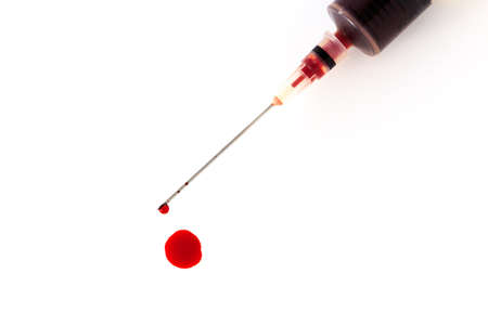 close up of the hypodermic needle and injector with blood dropの写真素材