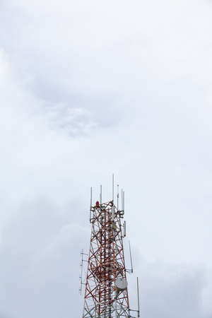 Telecommunication Tower , painted white and red in a day of clear blue sky 