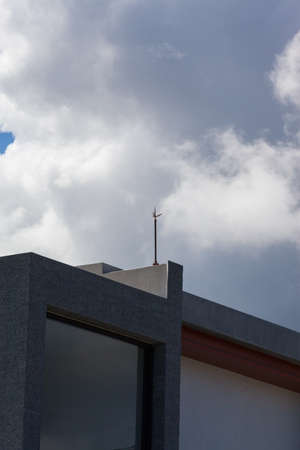 Lightning rod on top of building in daylight  and blue skyの写真素材