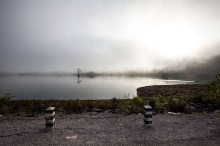 Foggy dams and small boat early morning の写真素材