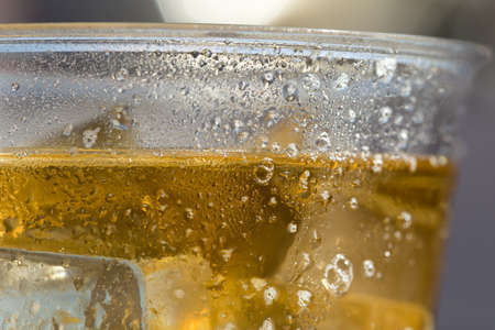 cold beer with ice in Disposable Cupの写真素材