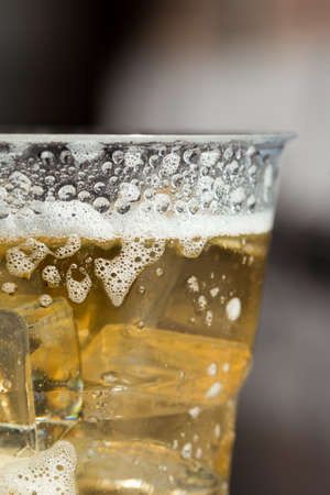 cold beer with ice in Disposable Cupの写真素材