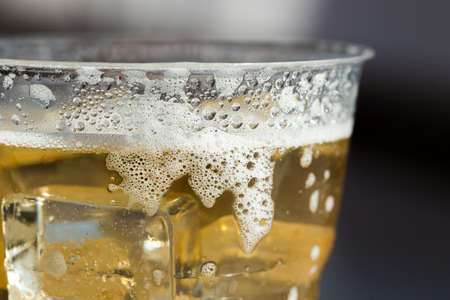 cold beer with ice in Disposable Cupの写真素材