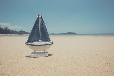 ship toy model in the sand on the beach.の写真素材