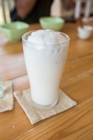 milkshake in glass on a wooden table.の写真素材