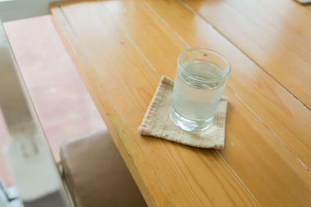 Glass with water on the wood table.の写真素材