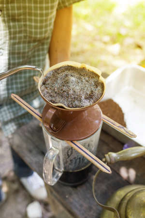 Hand drip coffee, Barista pouring  water on coffee ground with filter.の写真素材