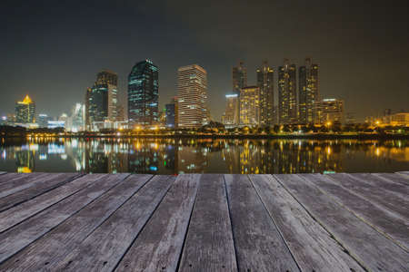 wooden floor and business district and reflection buildingの写真素材