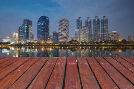 wooden floor and business district and reflection buildingの写真素材
