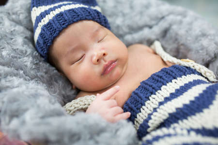 sleeping newborn baby in a basket.の写真素材